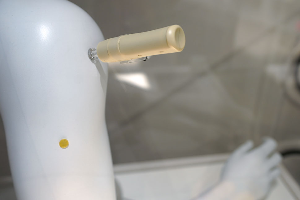 An einem angewinkelten Armmodell ist ein Injektor ohne Nadel angesetzt.